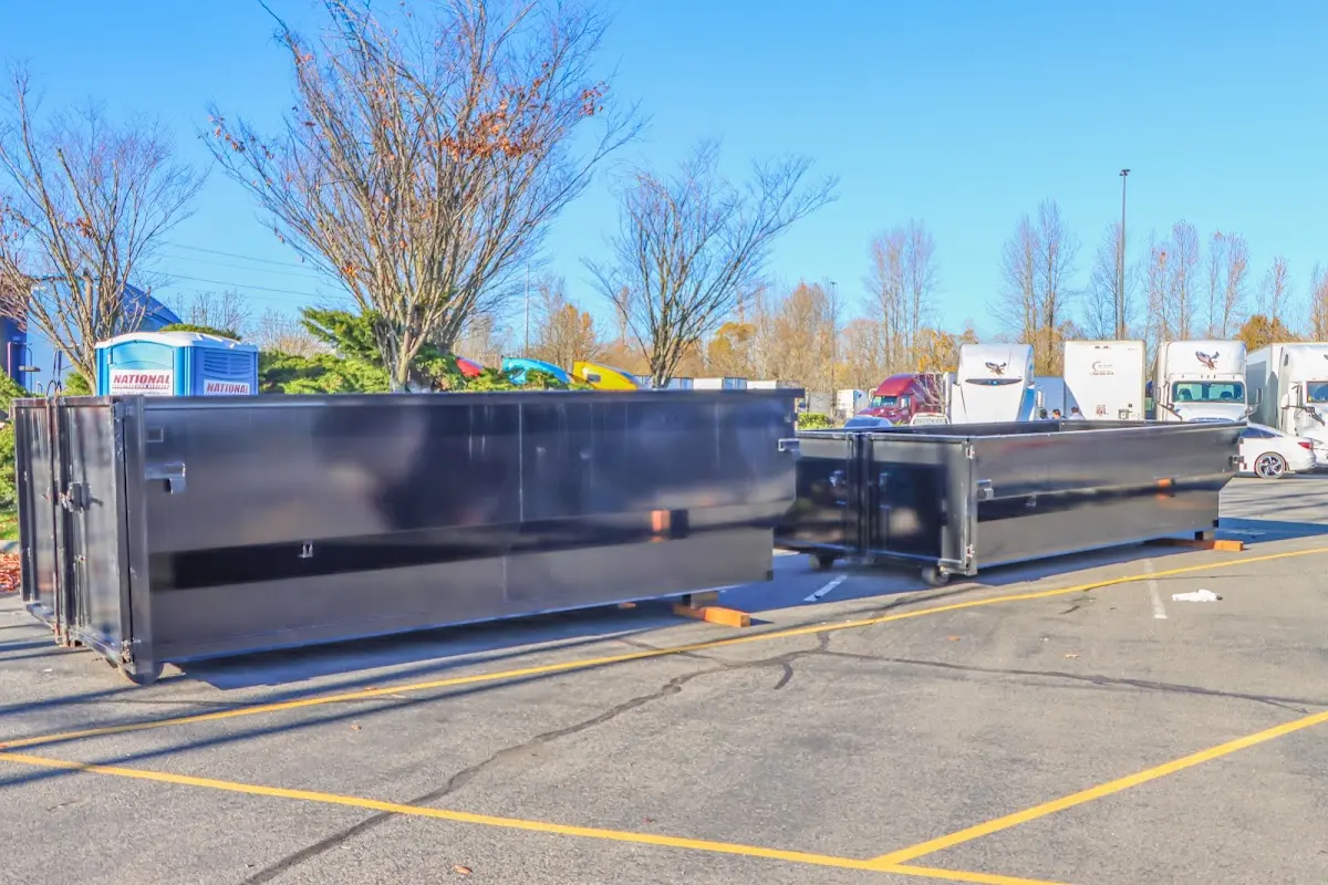 Professional dumpster rental service with roll-off container on residential driveway in Hawthorne